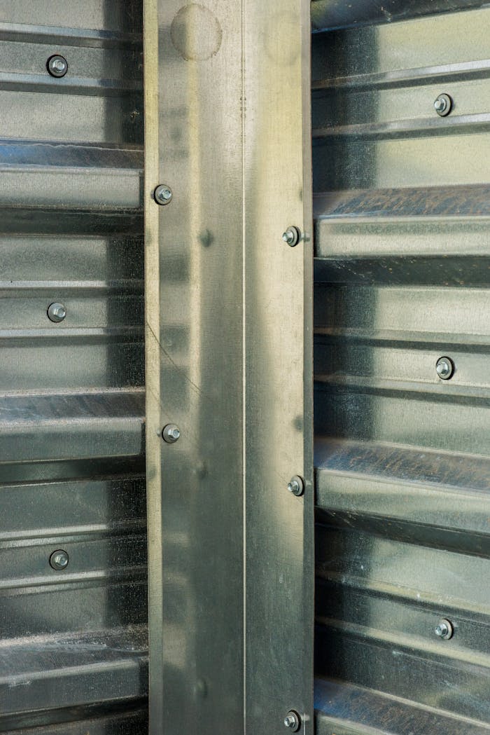 Detailed view of a metallic wall with screws, showcasing industrial design.